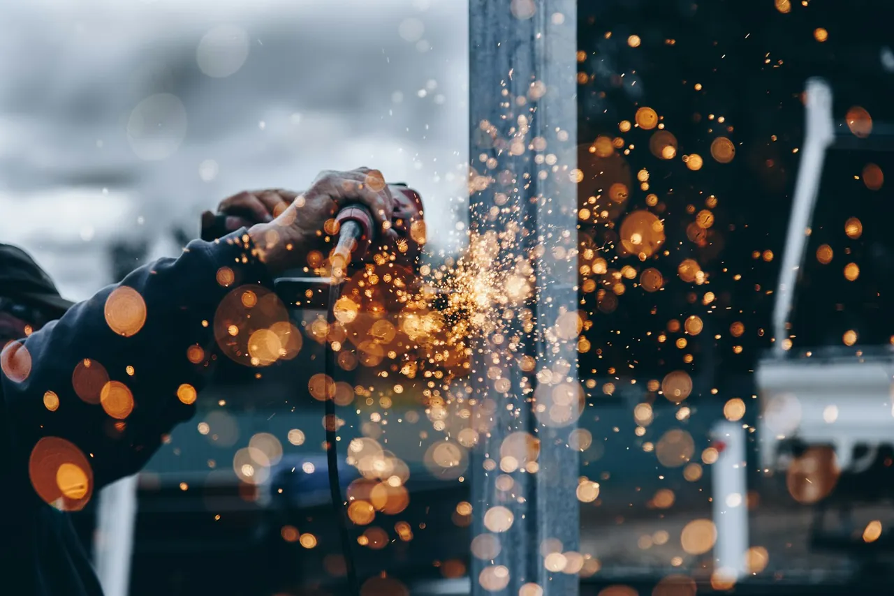 Metal fabrication work with protective equipment and sparks